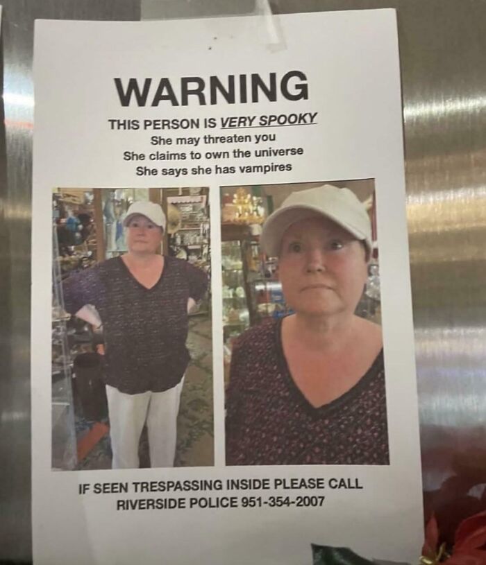 Warning sign showing a woman described as very spooky with humorous claims to own the universe and having vampires in cringe moment.