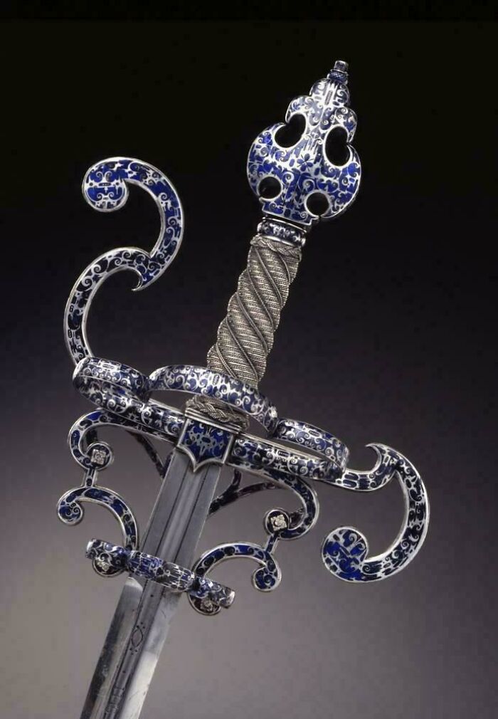 Antique sword with intricate blue and silver designs, showcasing almost perfectly preserved craftsmanship from history.