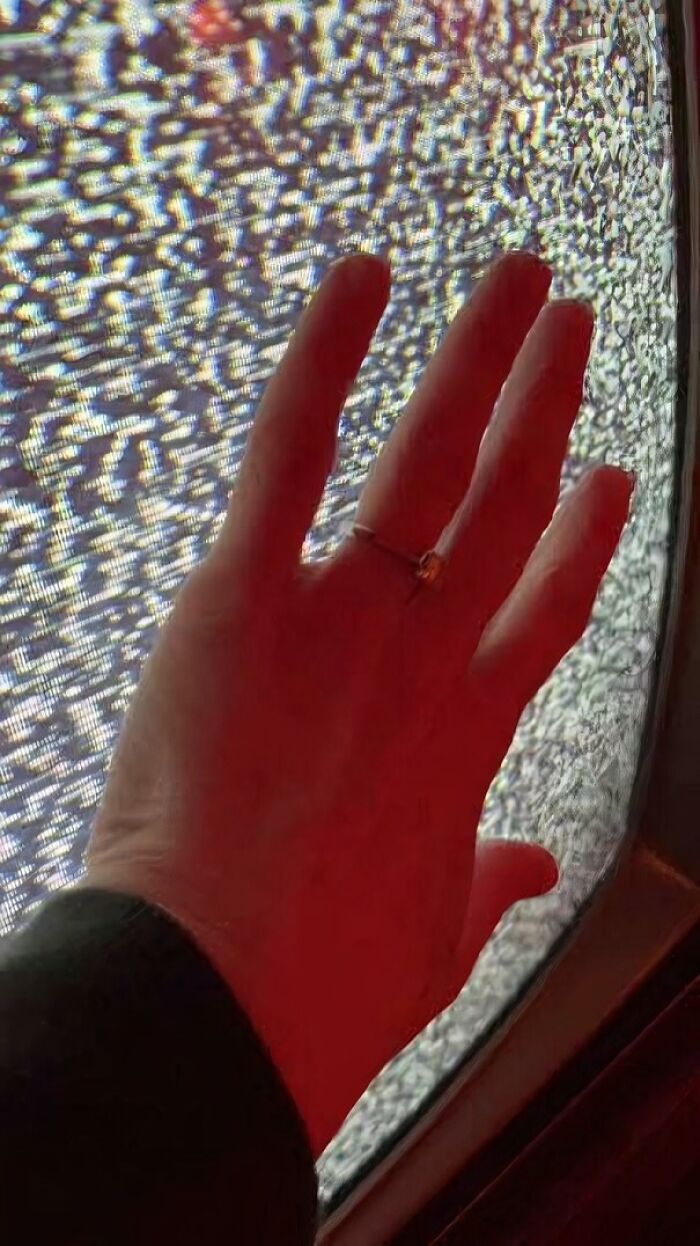 Hand touching a c*****d screen displaying static, evoking nostalgic feelings and funny 90s posts and memes.