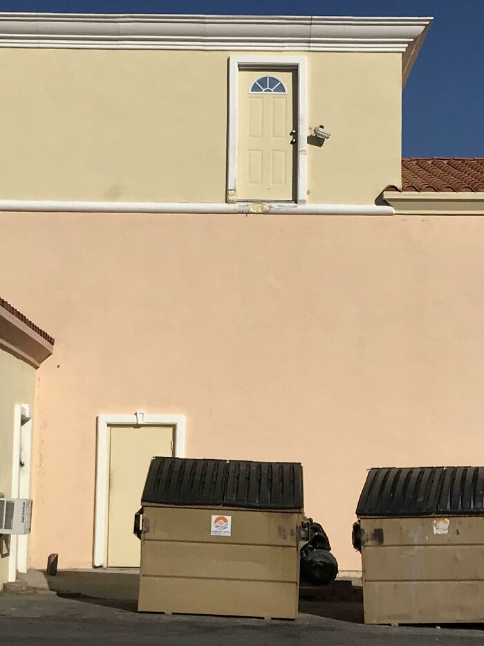 Door on upper wall leads absolutely nowhere, showcasing a clear failure in architectural design and planning.