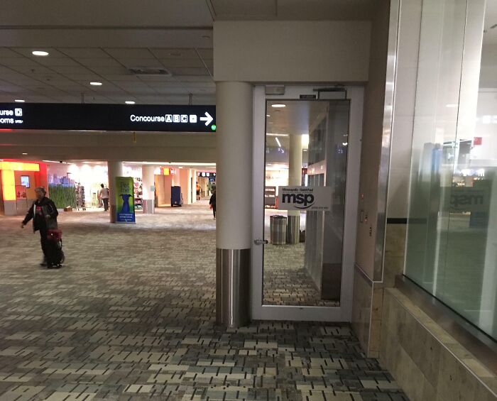Glass door in an airport terminal that leads nowhere, an example of architects failing with useless doors and design.