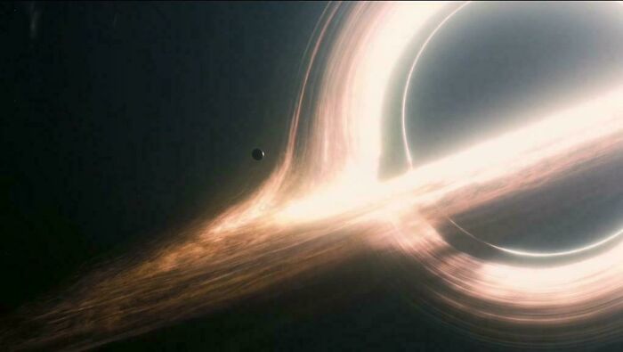A glowing black hole with a planet orbiting, a nonsensical movie detail.