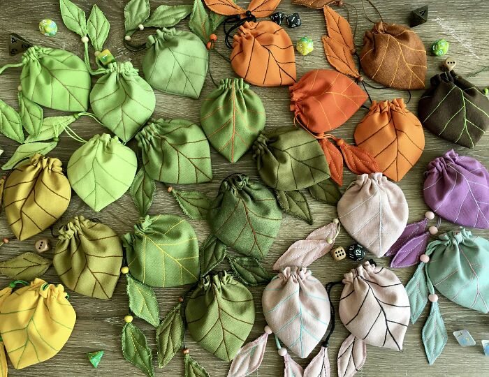 Assorted leaf-shaped fabric pouches in green, orange, and purple tones, showcasing creative DIY wins and handmade crafts.