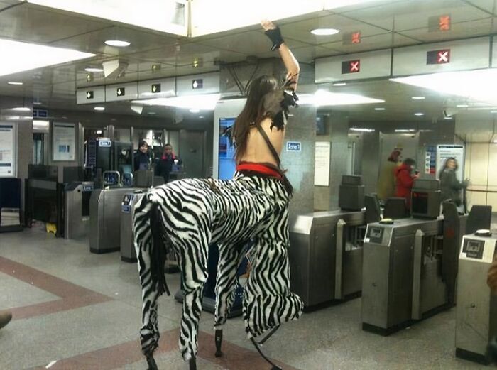 Person dressed as a zebra centaur costume in a NYC subway station, showcasing one of the weird moments on the subway.
