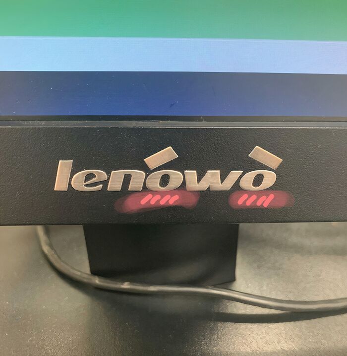 Close-up of a Lenovo computer monitor with altered logo, highlighting weirdest subreddits and popular online communities.