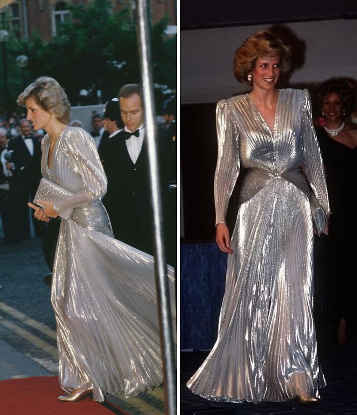 Elegant historical garment in shimmering silver fabric with pleated design and structured shoulders at a formal event.