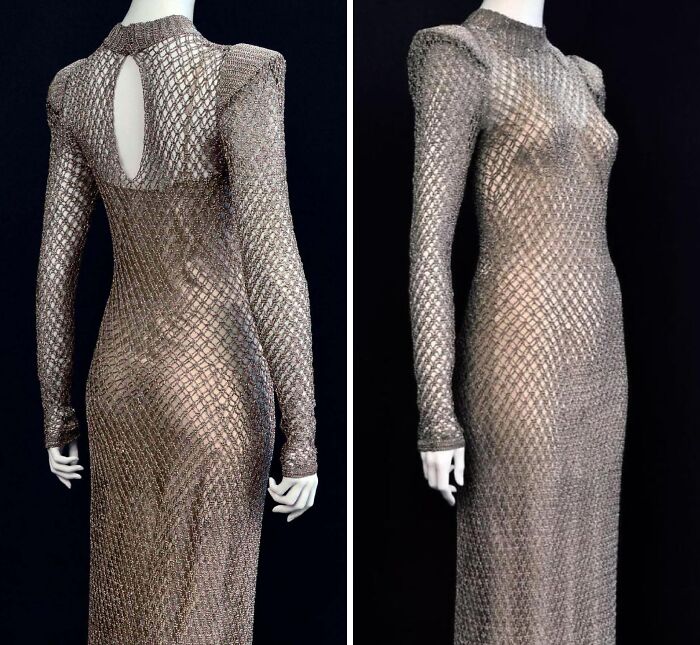 Intricately designed historical garment with a metallic mesh pattern, long sleeves, and a high neckline displayed on a mannequin.