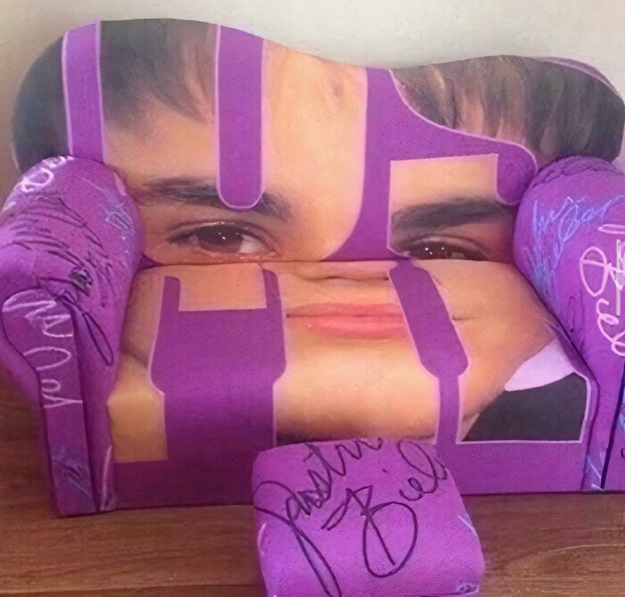 Purple fabric furniture piece with a distorted human face print, an example of ridiculous pieces of furniture shared online.