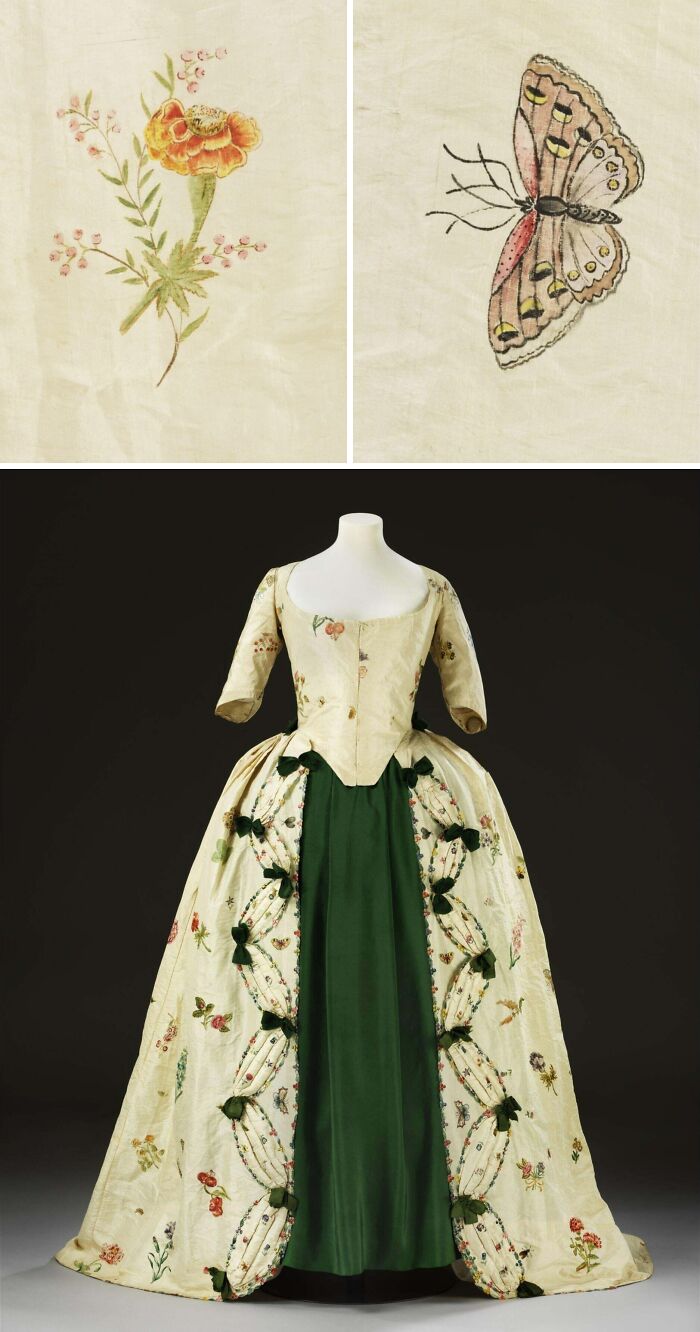 18th century historical garment with floral embroidery and butterfly details, featuring a green satin skirt and decorative bows.