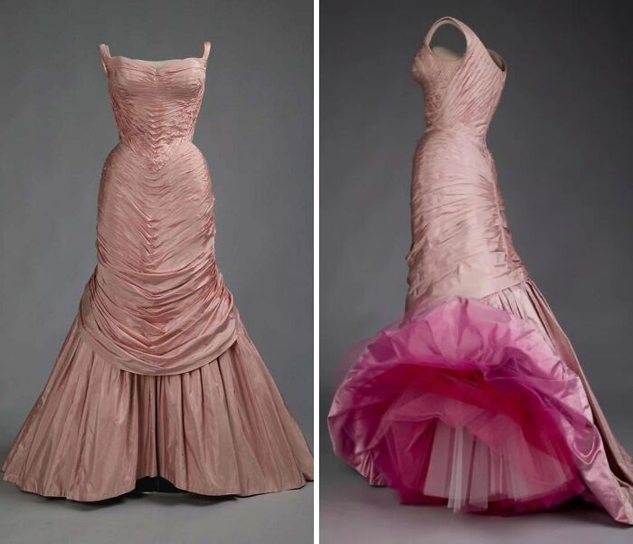 Vintage pink historical garment with ruched bodice and full skirt, showcasing intricate fabric details and classic design elements.
