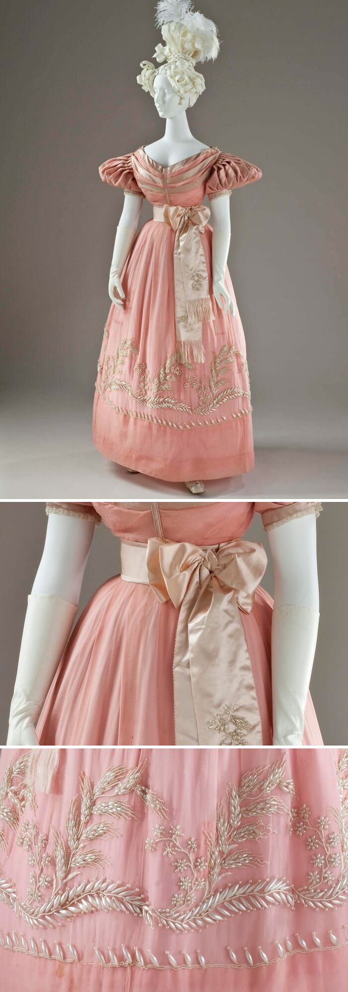 Pink historical garment with puffed sleeves, embroidered floral details, and a large bow sash on a white mannequin.