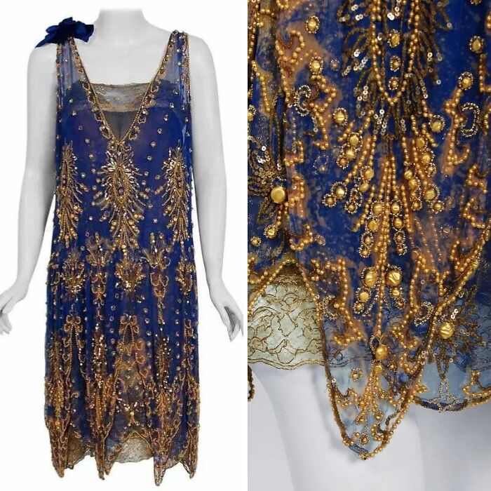Blue vintage historical garment with intricate gold bead and sequin embroidery on sheer fabric displayed on mannequin.