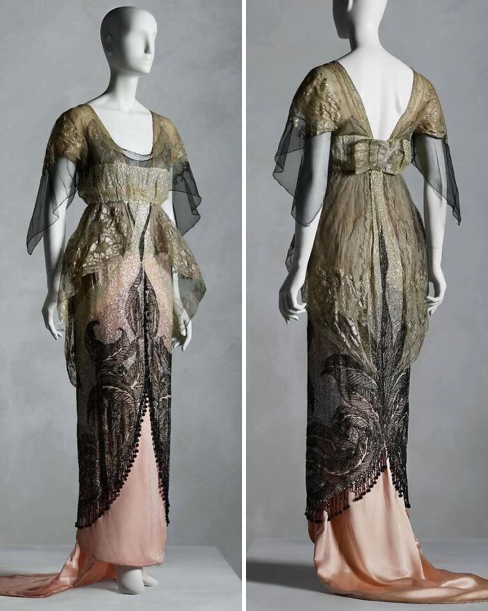 Mannequin wearing an ornate historical garment with black and gold lace overlay and a long pink satin skirt.