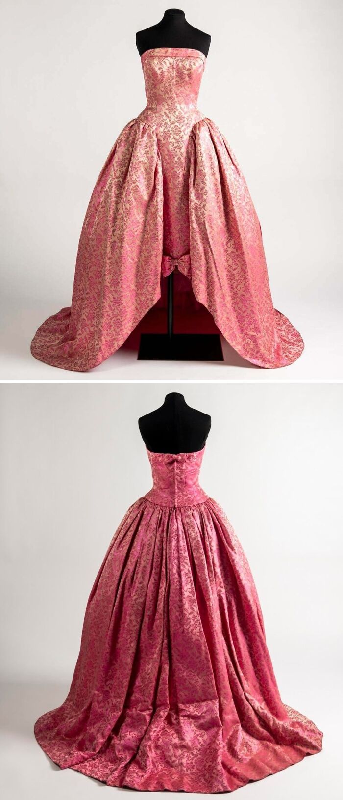 Pink historical garment with floral brocade pattern displayed front and back on a black mannequin stand.