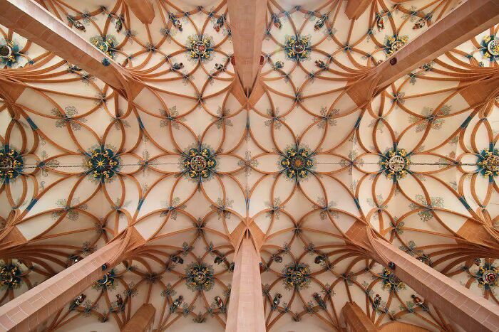 An intricate and beautiful architecture ceiling with elaborate patterns and designs.