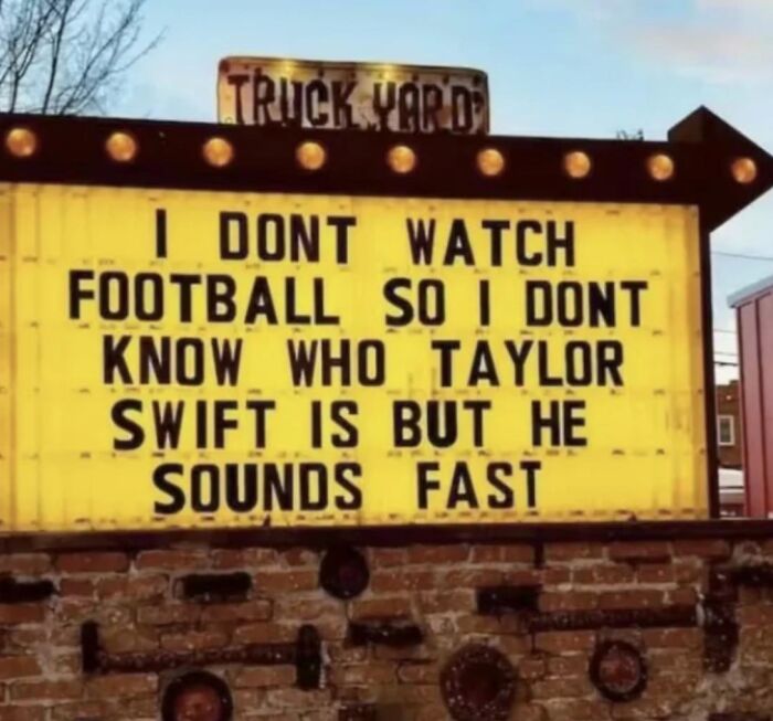 Funny strange sign confusing Taylor Swift with a fast football player at a truck yard, showcasing unusual strange signs humor.