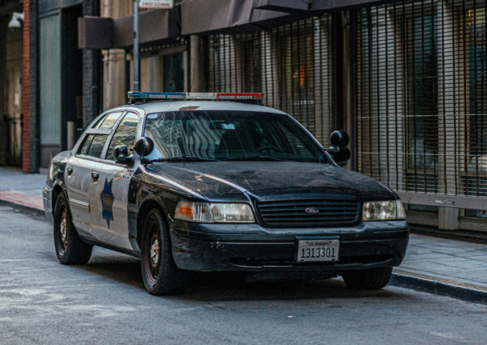 Black and white police car parked on an urban street illustrating quick fixes that turned out genius.