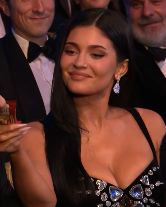 Kylie Jenner at the 2026 BAFTAs wearing diamond earrings and a black dress, fans spot lip detail change.