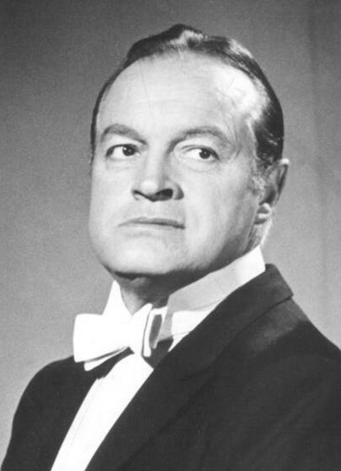 Black and white portrait of a man in a tuxedo, related to Oscars hosting and Conan O'brien's return news.