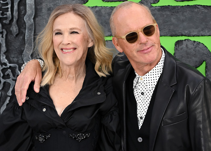 Catherine O'Hara and a man smiling together at an event, highlighting cause of Catherine O'Hara's passing.