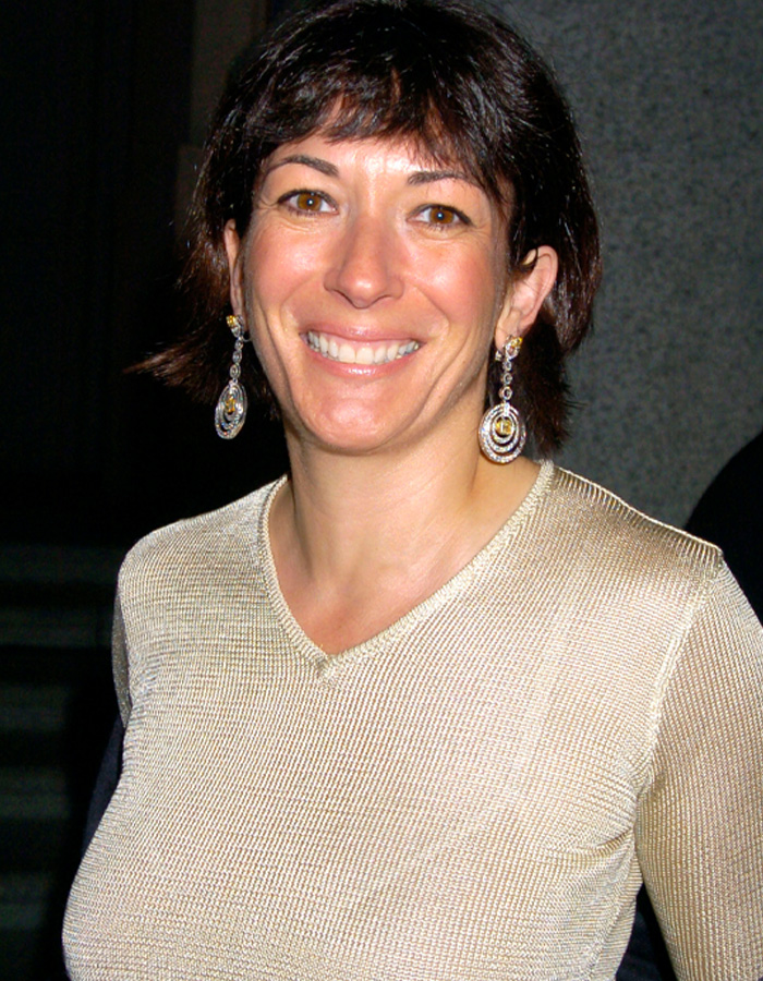 Ghislaine Maxwell smiling, wearing silver earrings and a light-colored top, as internet users question her prison appearance.