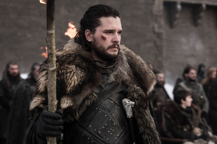 Jon Snow dressed in fur cloak and armor in a medieval setting, representing Aegon Targaryens in Game of Thrones universe.