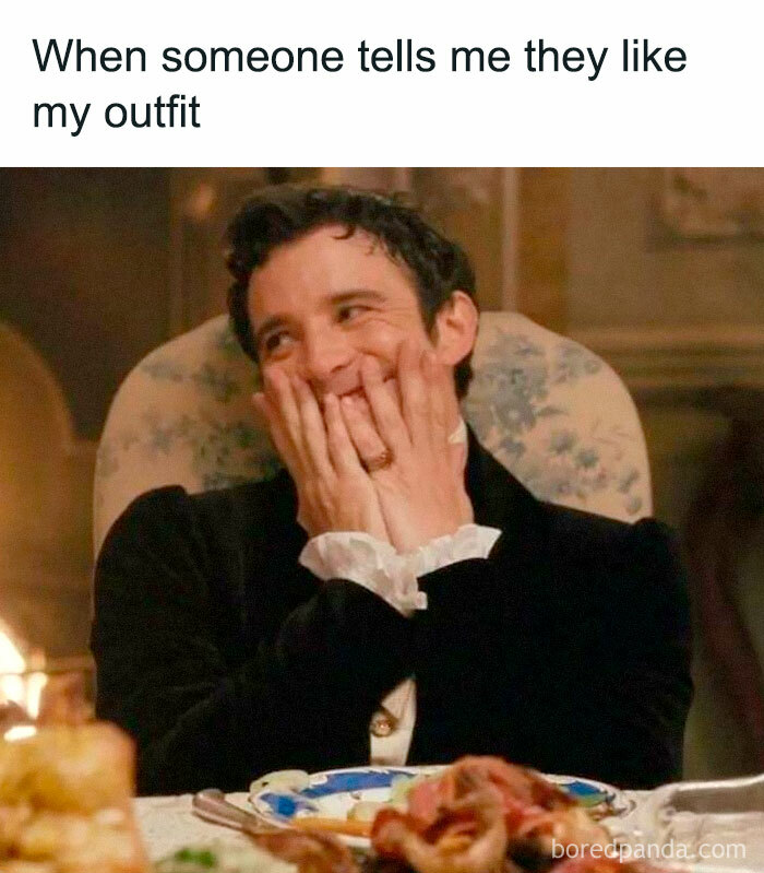 Man from Bridgerton smiling shyly at the dinner table, relatable Bridgerton memes fans of the show might love.