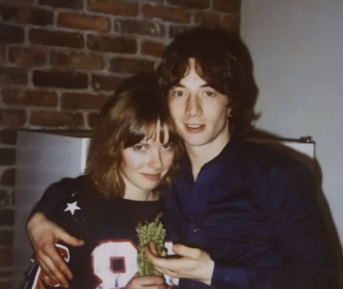 Young couple posing indoors near a brick wall, related to harrowing 911 audio after Katherine's tragic loss.