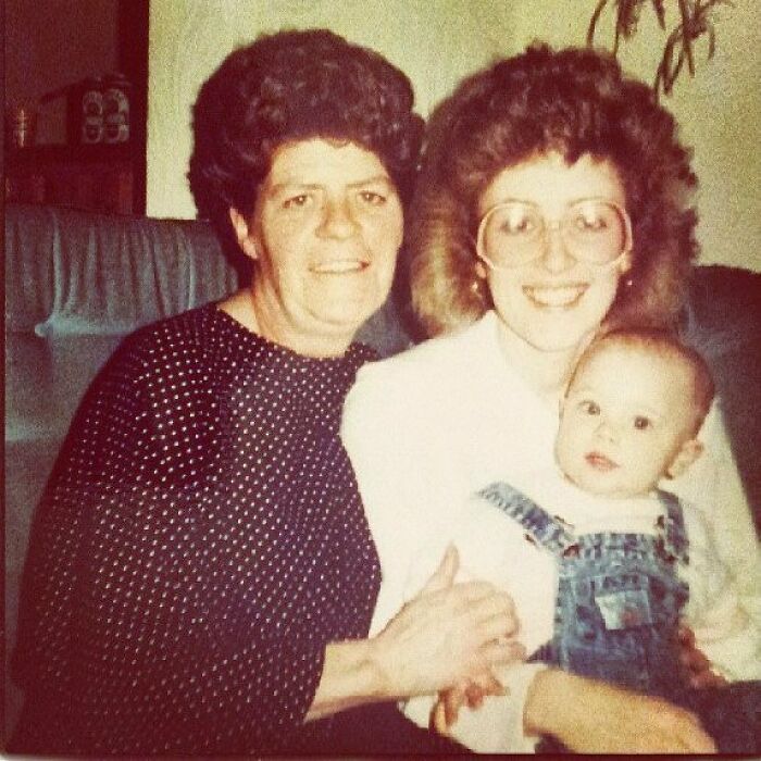 Two women and a baby, showcasing iconic 80s hairdos with voluminous and curly styles from the era.