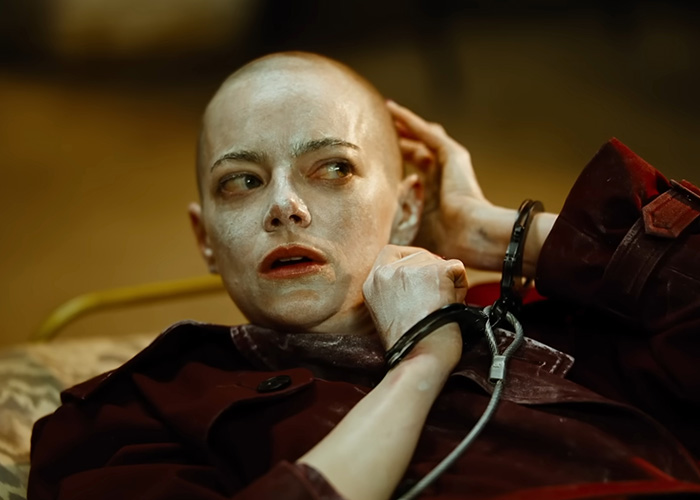 Close-up of a distressed bald woman in handcuffs, a scene from Oscar nominated movies 2026, intense and dramatic moment.