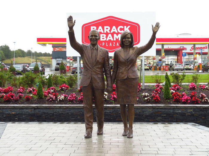 Bronze statues of a man and woman waving at Barack Obama Plaza, one of the unusual places with unique Wikipedia pages.