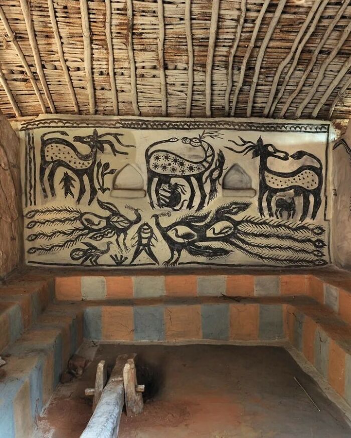 Rustic bold and beautiful interiors with traditional animal murals and natural thatched ceiling in an earthy, cultural setting.