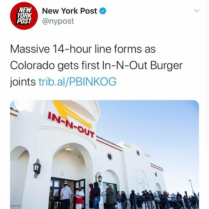 People waiting in a long line outside In-N-Out Burger in Colorado, illustrating unhinged news headlines in America.
