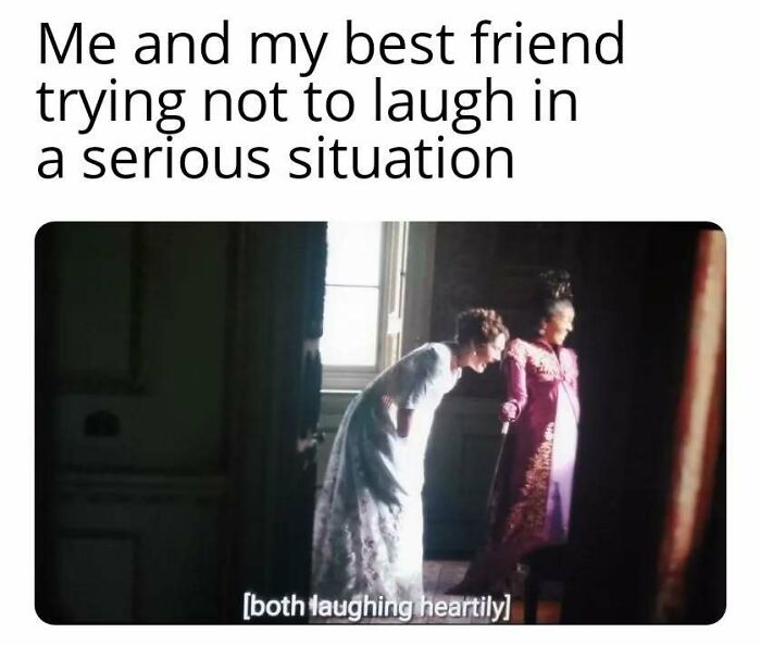 Two women in period costumes laughing quietly in a dim room, capturing a Bridgerton meme moment about serious situations.