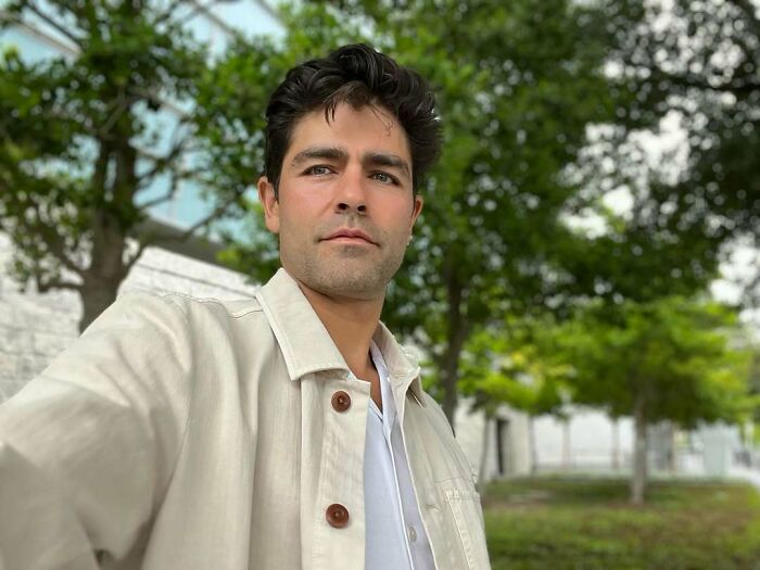 Young man with dark hair wearing a beige jacket outdoors among trees, illustrating iconic actors who vanished without explanation.