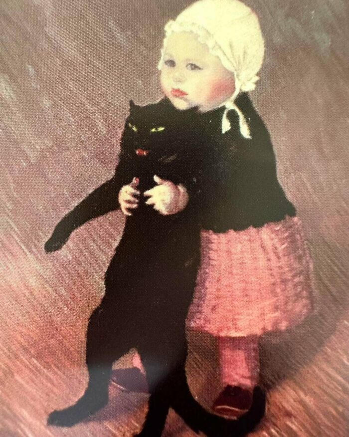Child in vintage clothing holding a large black cat painting symbolizing cats as favorite art subjects over the years