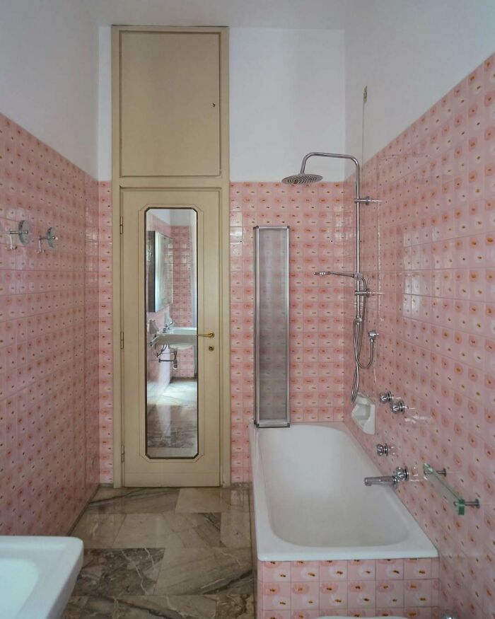 Bathroom with bold pink patterned tiles and modern fixtures showcasing beautiful interiors design.
