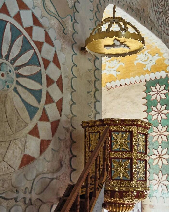 Ornate bold and beautiful interiors featuring intricate gold details and colorful hand-painted wall designs in historic setting.