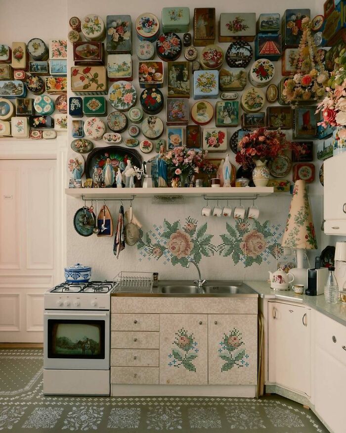 Vintage kitchen with bold floral patterns and beautiful decorative tins creating striking bold and beautiful interiors.