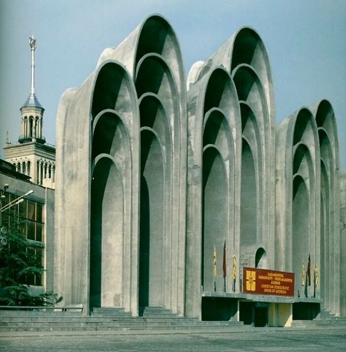 Modern architectural structure with large concrete arches, showcasing creativity in building design and construction.