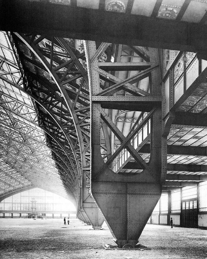 Massive steel architectural structure with intricate trusses and beams showcasing humanity's creativity in design and engineering.