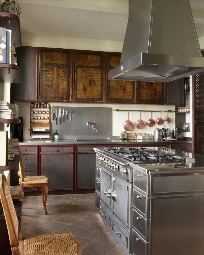 Bold and beautiful interiors featuring a stylish kitchen with vintage cabinets and modern stainless steel appliances.