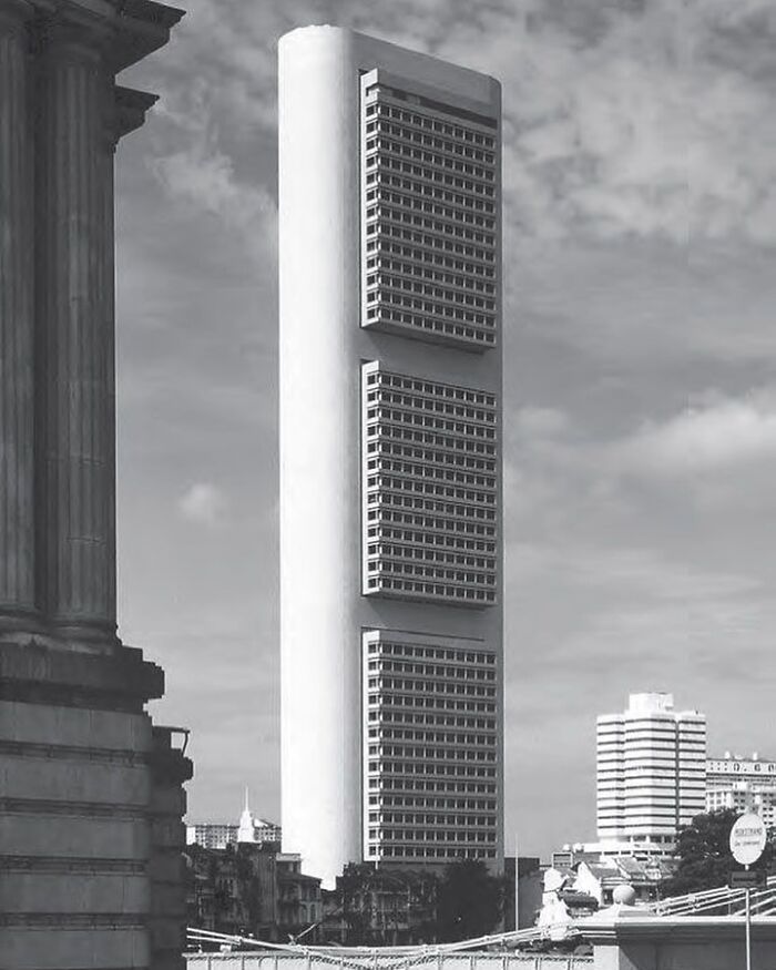 Tall modern architectural structure with unique geometric window patterns showcasing humanity's creativity in design.