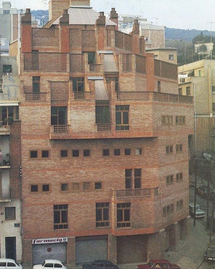 Unique brick architectural structure showcasing humanity's creativity and innovative building design in an urban setting.