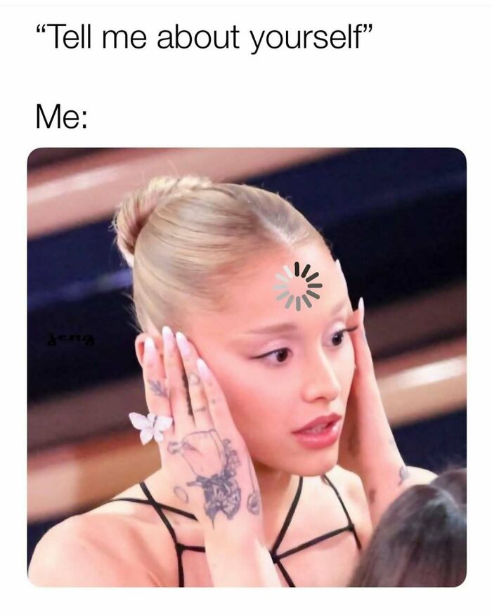 Woman with tattoos and butterfly ring holding her head with a confused expression, representing cute and wholesome posts for girlies.
