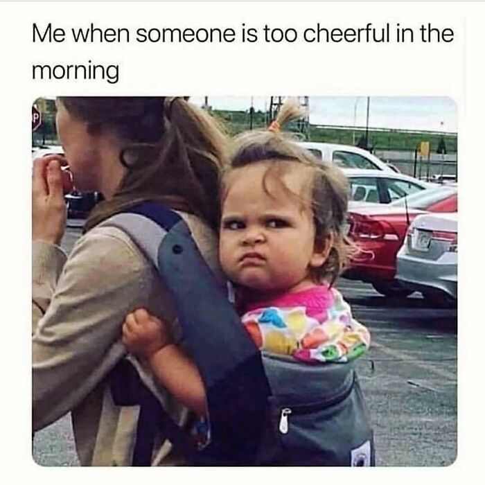 Toddler making a grumpy face while being carried by adult, capturing a cute and wholesome moment for girlies posts.