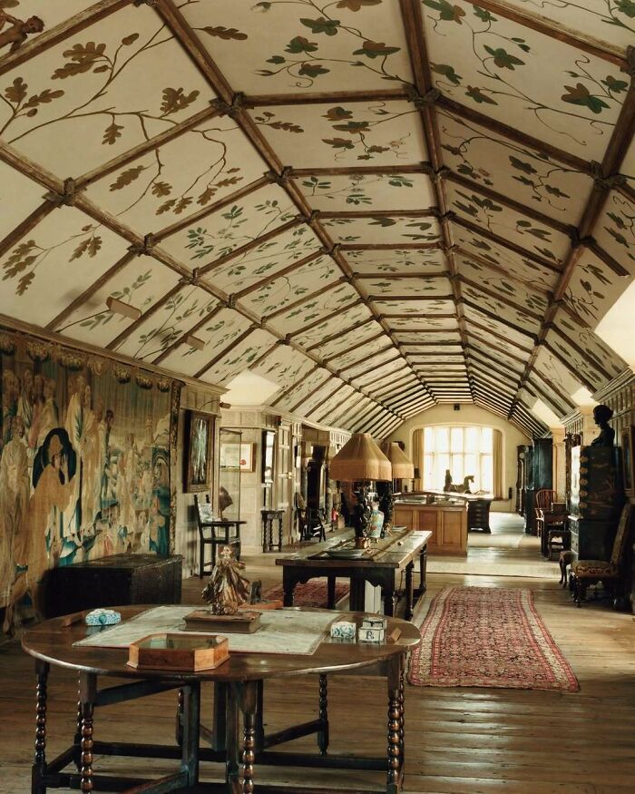 Vintage bold and beautiful interiors featuring detailed ceiling artwork, antique furniture, and ornate decor in a spacious room.