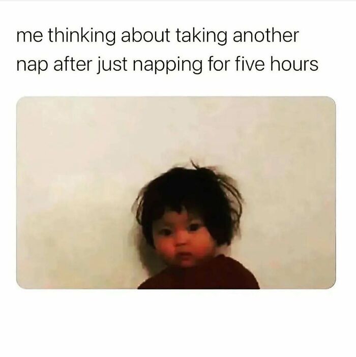 Young child with messy hair looking tired, illustrating a cute and wholesome post about thinking of taking another nap.