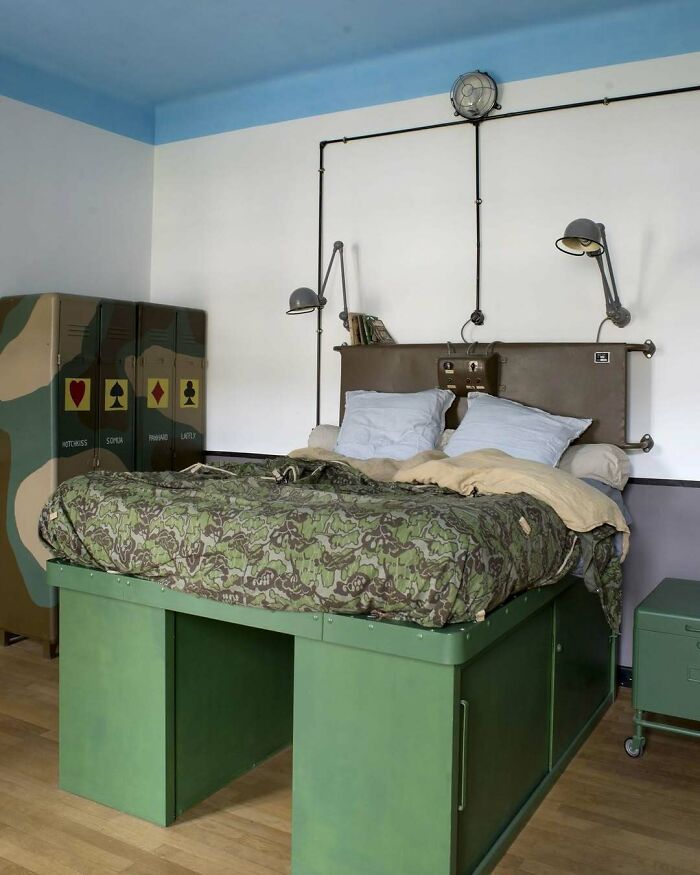 Bold and beautiful interiors featuring a military-inspired bedroom with camouflage bedspread and industrial lighting accents
