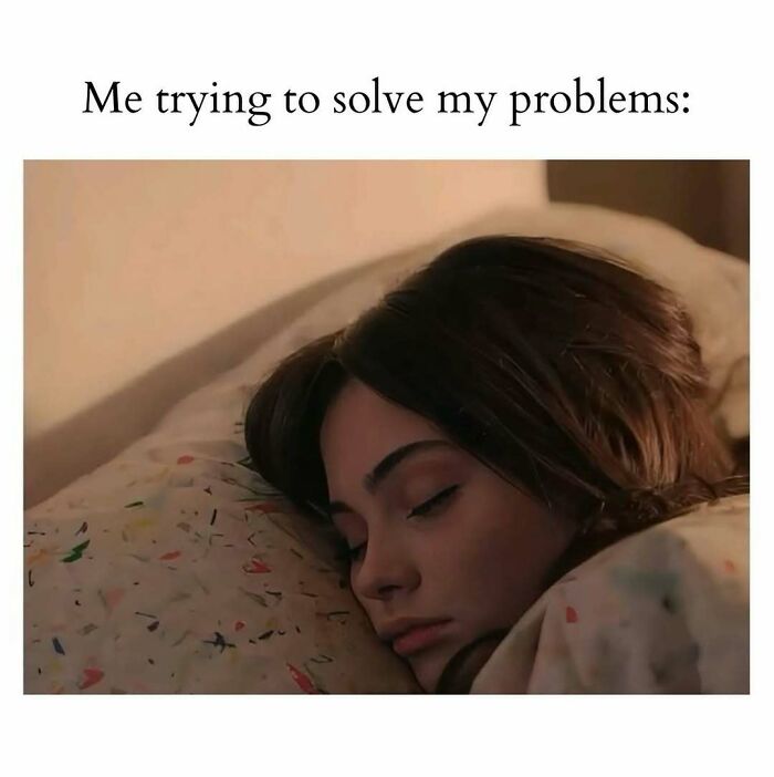 Young woman lying in bed with eyes closed, peacefully resting, representing cute and wholesome posts for girlies.